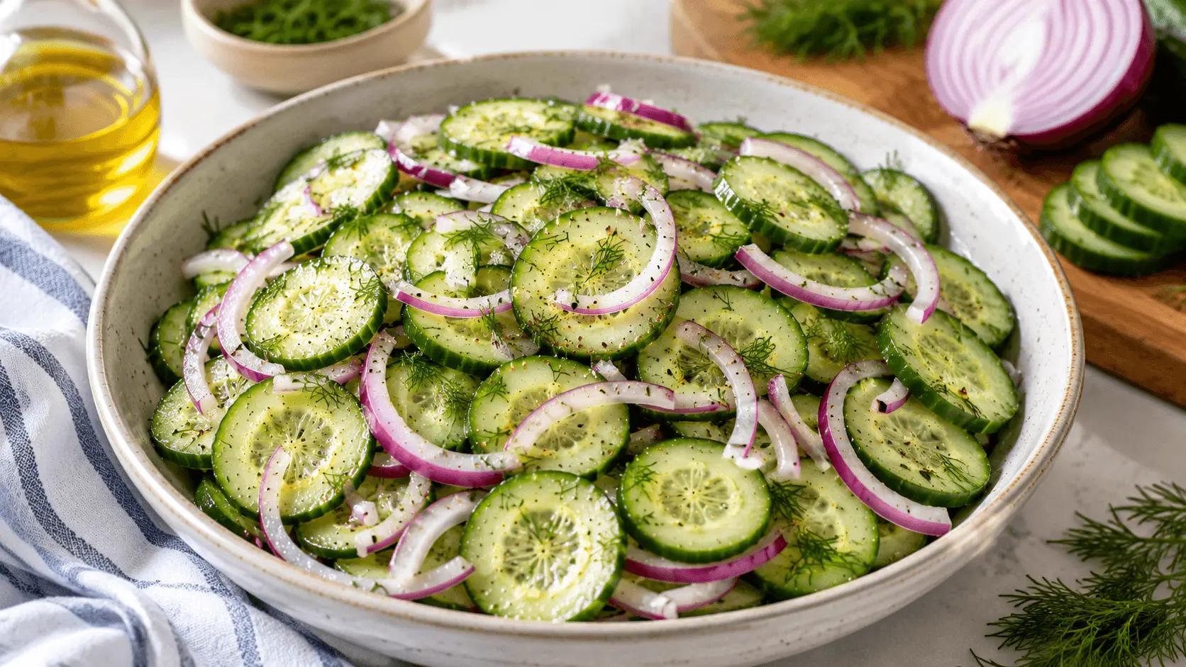 Cucumber and Onion Salad with thin cucumber slices, red onion, fresh dill, black pepper, and a light vinegar dressing in a white bowl.